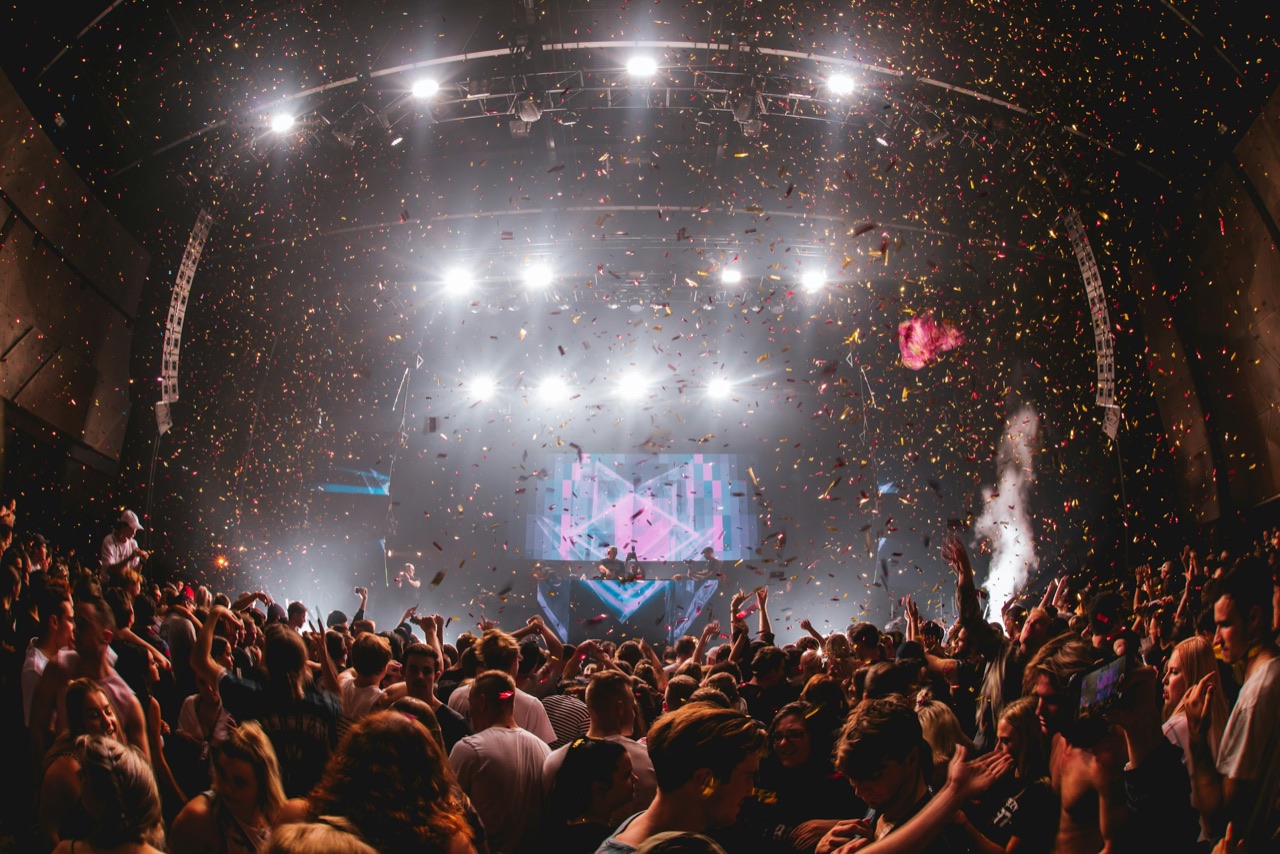 Confetti falling over a packed crowd at a club night